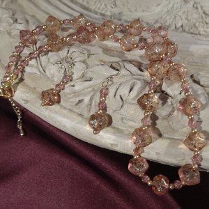 Artisanal necklace/earring set in faceted rose beads with  gold accents